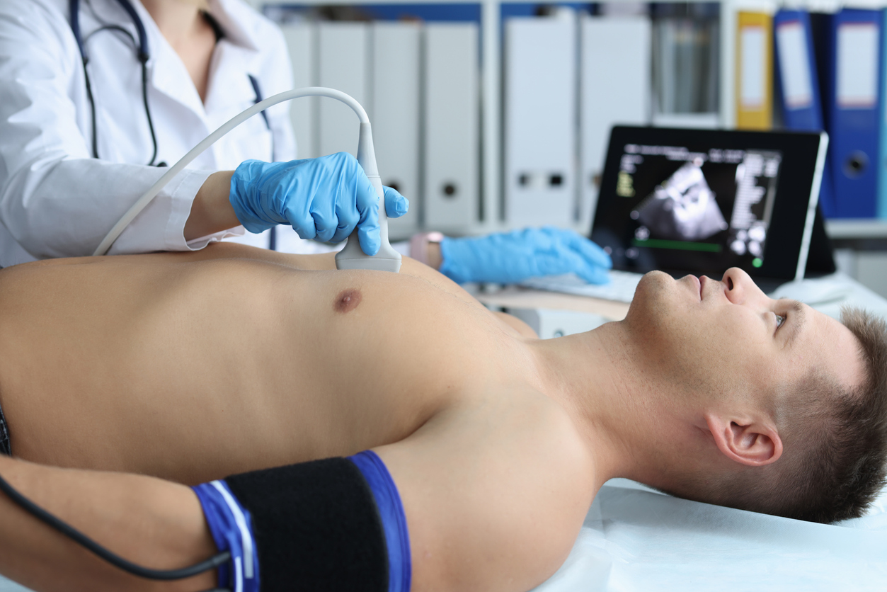 The image shows a man during an echocardiogram to show who is a candidate for echocardiography.